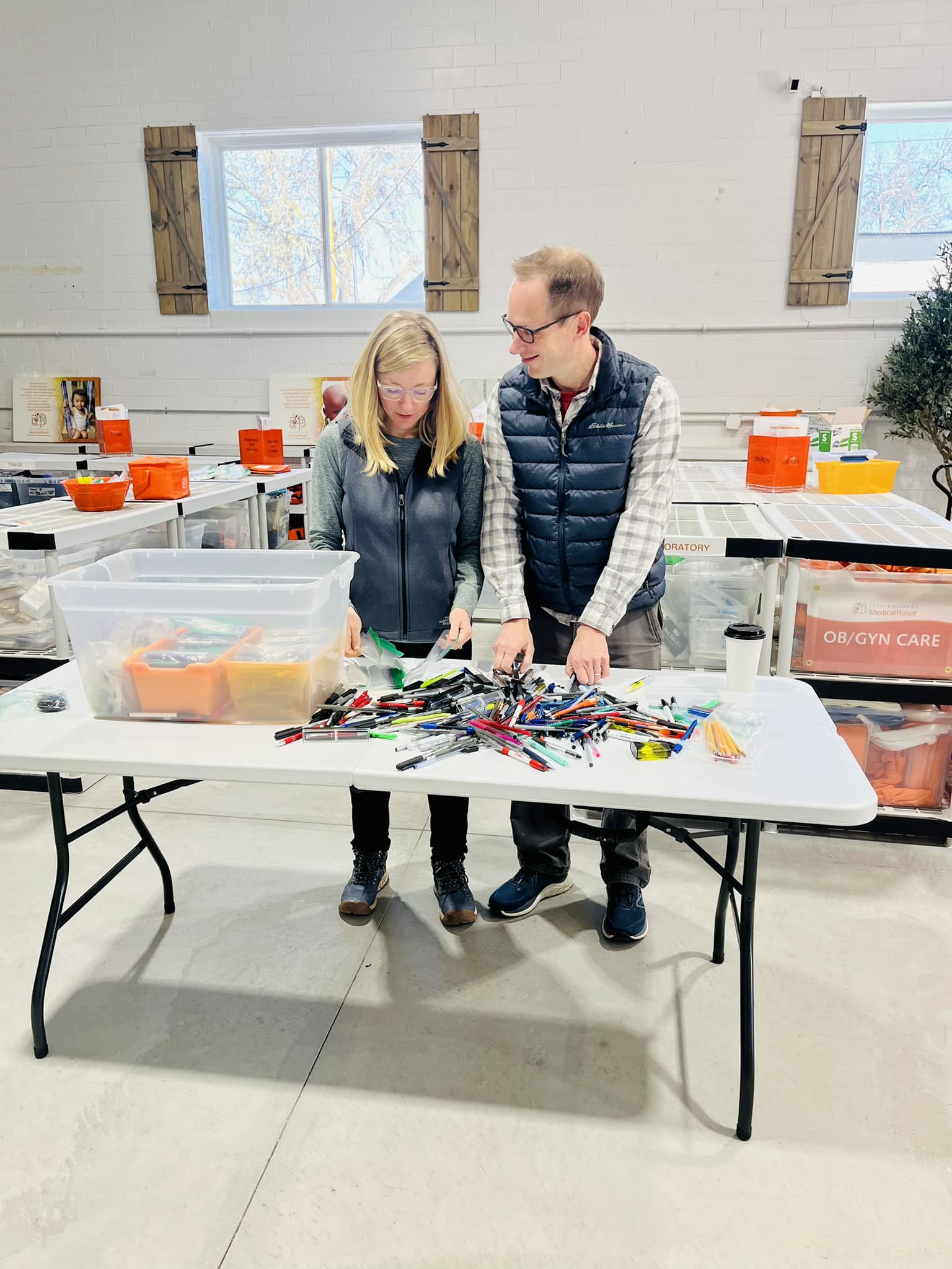 Doug and Tess MacQueen volunteering with Pine Point Medical, sorting supplies for International Medical Relief in Colorado