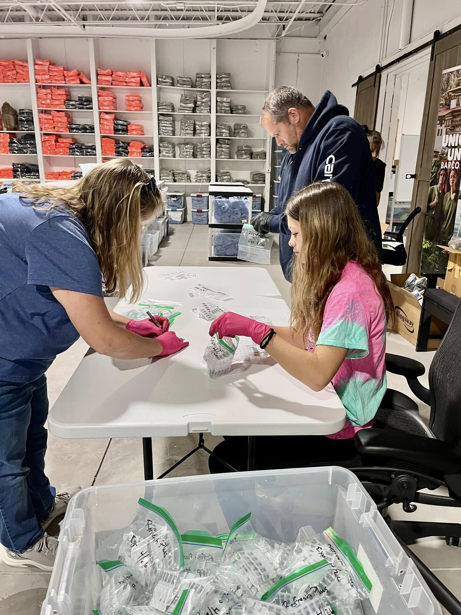 Pine Point Medical team and family members volunteering with International Medical Relief in Colorado, packing medical supplies for global missions.