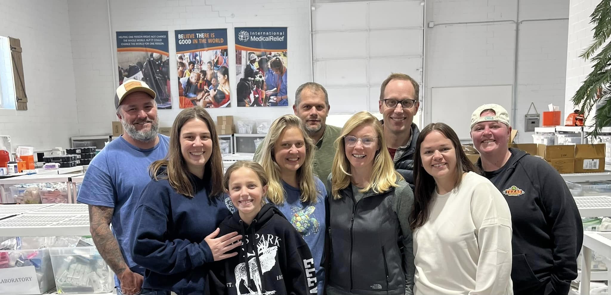 Group photo of Pine Point Medical team volunteering with International Medical Relief in Colorado to pack medical supplies for global missions.