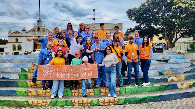 Pine Point Medical volunteers standing with Ecuadorian community members during medical mission trip