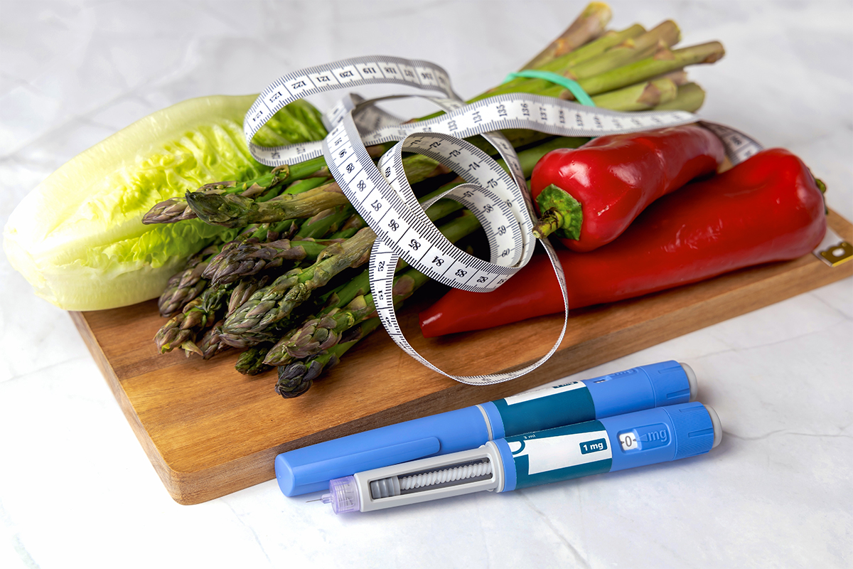 Fresh vegetables, measuring tape, and GLP-1 weight loss injection pens representing semaglutide and tirzepatide treatments at Pine Point Medical